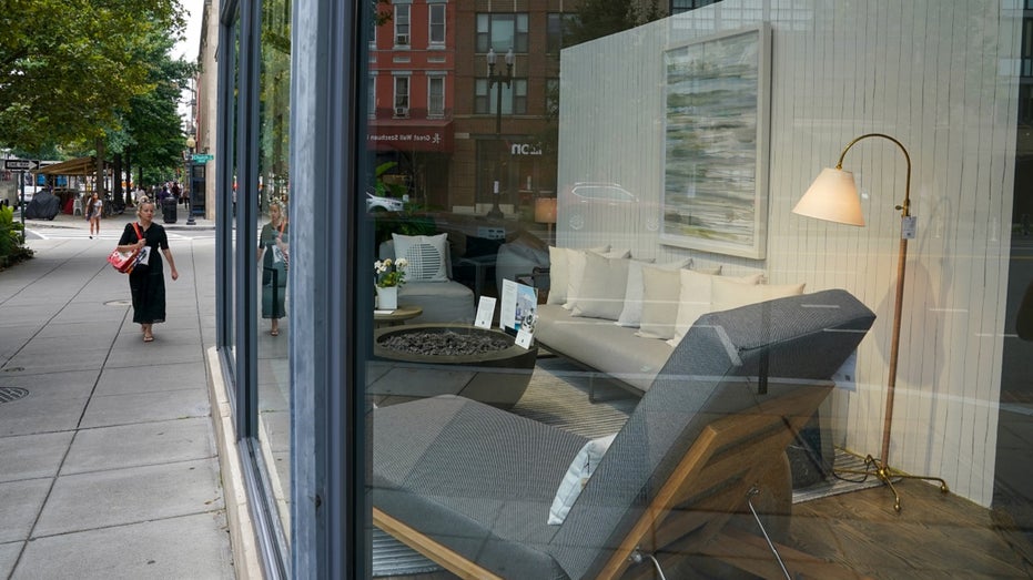 woman walks by Mitchell Gold store in Washington, DC