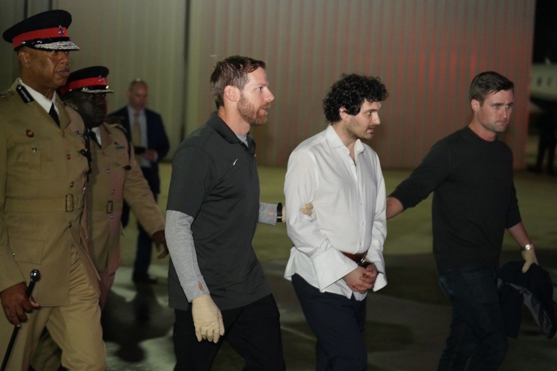 Sam Bankman-Fried leaving the Bahamas on December 21, 2022, being extradited to the US to face charges. He is shown here at the airport before boarding a flight to the United States.