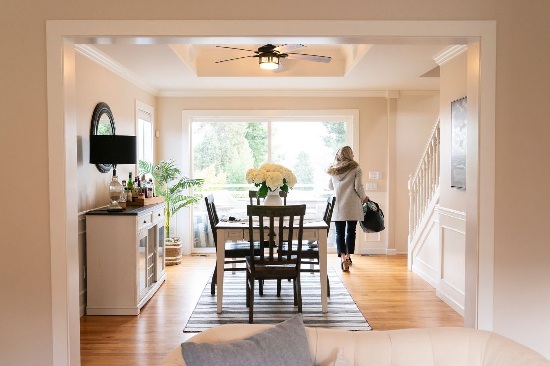 A realtor walks through the dining room during an open house at a home in Seattle, Washington, US, on Tuesday, March 26, 2024. The National Association of Realtors agreed to settle litigation over commission rules for US real estate agents, clearing the way for possible changes in how Americans buy and sell homes.